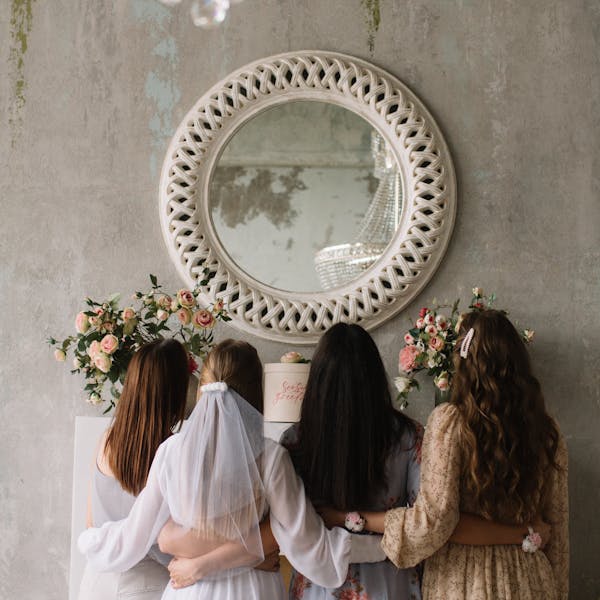 A group of women hugging at a bridal shower with elegant decor. Perfect for wedding themes.
