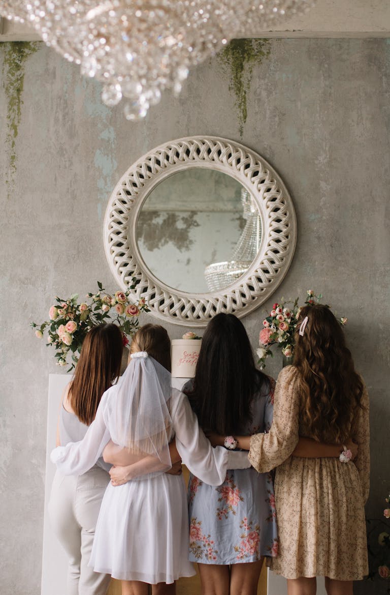 A group of women hugging at a bridal shower with elegant decor. Perfect for wedding themes.